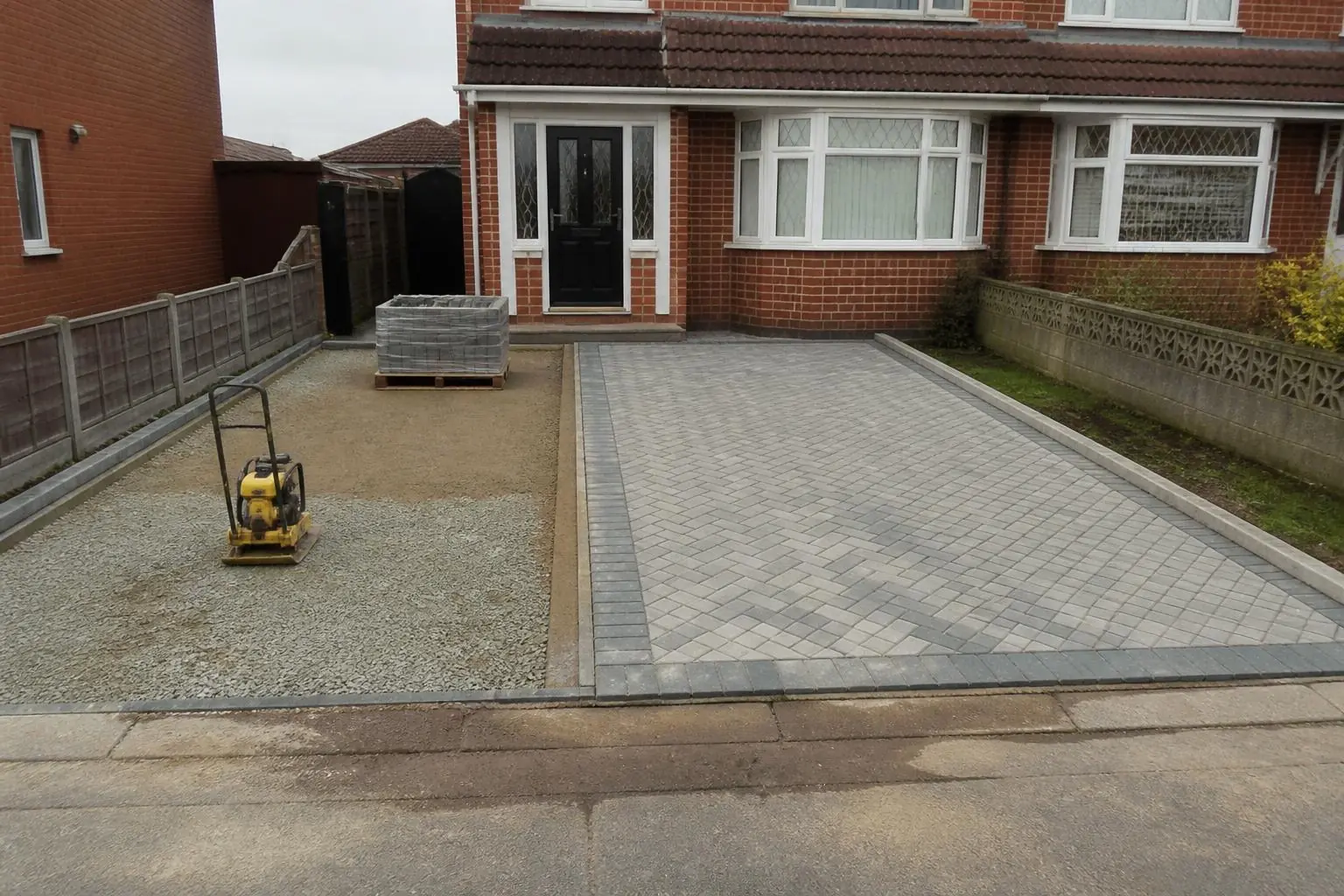 Example image: block paving part-laid on a screeded sand bed over a compacted stone sub-base
