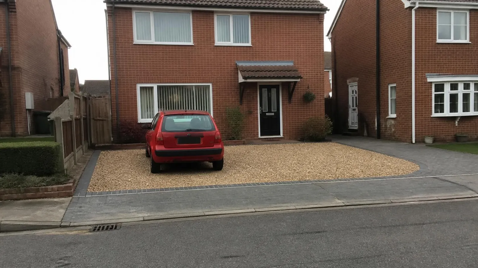 Gravel driveway with sett edging and a solid block apron at the pavement